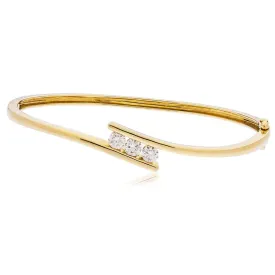 DIAMOND THREE STONE CROSS OVER BANGLE IN 9K YELLOW GOLD